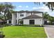 A beautiful two-story home with a lush green lawn and manicured landscaping at 1840 Bryan Ave, Winter Park, FL 32789