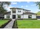 A beautifully landscaped two-story home with a lush green lawn at 1840 Bryan Ave, Winter Park, FL 32789