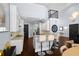 Eat-in kitchen featuring white cabinetry, granite countertops, and stainless steel appliances, with a view of the loft at 1840 Bryan Ave, Winter Park, FL 32789