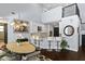 Eat-in kitchen features stainless appliances, white cabinets, granite countertops, and a view to the dining area at 1840 Bryan Ave, Winter Park, FL 32789