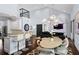 Open living area with views of the dining area, kitchen, and living room with entertainment center at 1840 Bryan Ave, Winter Park, FL 32789