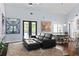 Open-concept living area with a comfortable couch, dining area, and contemporary design elements at 1840 Bryan Ave, Winter Park, FL 32789