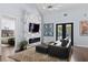 Sophisticated living room with a marble fireplace, sleek TV, and comfortable seating area at 1840 Bryan Ave, Winter Park, FL 32789