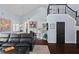 Bright living room boasts dark wood floors, stairs to loft, and an open view to the kitchen and dining area at 1840 Bryan Ave, Winter Park, FL 32789