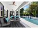 Cozy covered patio features outdoor seating and a view of the pool and garden at 1840 Bryan Ave, Winter Park, FL 32789
