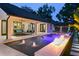 Inviting pool area with fountains, a fire feature, and cozy patio seating for outdoor relaxation at 1840 Bryan Ave, Winter Park, FL 32789