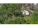 Unique aerial perspective showing acreage, large trees, pool and water feature at 20 Lido Rd, Winter Springs, FL 32708