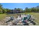 Inviting backyard area featuring a fire pit surrounded by chairs and a screened-in pool in the background at 20 Lido Rd, Winter Springs, FL 32708