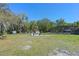 Large backyard with a screened pool enclosure, shed, and comfortable seating area with a fire pit at 20 Lido Rd, Winter Springs, FL 32708