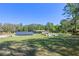 Expansive backyard featuring green grass, mature trees, solar panels, and outdoor amenities at 20 Lido Rd, Winter Springs, FL 32708