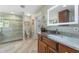 Elegant bathroom featuring a glass shower, marble counters, and modern fixtures at 20 Lido Rd, Winter Springs, FL 32708