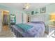 Bright bedroom with a ceiling fan, large closet, and a mirror that reflects natural light into the space at 20 Lido Rd, Winter Springs, FL 32708