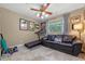 Flex bedroom features a black leather couch, exercise equipment, and window view at 20 Lido Rd, Winter Springs, FL 32708