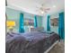 Charming bedroom features blue curtains, neutral walls, and ceiling fan at 20 Lido Rd, Winter Springs, FL 32708