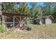 Rustic chicken coop and shed nestled in a natural setting, providing a quaint country feel at 20 Lido Rd, Winter Springs, FL 32708