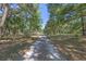 A long gravel driveway leading to the house, creating a sense of privacy and seclusion at 20 Lido Rd, Winter Springs, FL 32708
