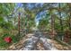 Gated driveway entrance with shade trees leading to the home at 20 Lido Rd, Winter Springs, FL 32708