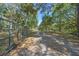 Gated driveway entrance with an artistic sun and moon at 20 Lido Rd, Winter Springs, FL 32708
