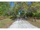 Long driveway leading to a home shaded with mature trees at 20 Lido Rd, Winter Springs, FL 32708