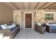 Inviting covered front porch with stone accents and cozy seating, perfect for relaxing outdoors at 20 Lido Rd, Winter Springs, FL 32708