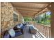 Relaxing covered front porch with ample seating, stylish decor, and tongue and groove ceiling at 20 Lido Rd, Winter Springs, FL 32708