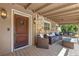 Covered front porch with seating area, exterior lighting, and wood-look floors at 20 Lido Rd, Winter Springs, FL 32708