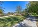 Charming exterior of home with mature trees, long driveway, and lush green lawn at 20 Lido Rd, Winter Springs, FL 32708
