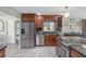 Well-appointed kitchen with stainless steel appliances, dark cabinets, and sleek countertops at 20 Lido Rd, Winter Springs, FL 32708