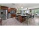 Spacious kitchen with a central island, stainless steel appliances, and dark cabinetry for modern elegance at 20 Lido Rd, Winter Springs, FL 32708