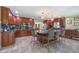 Gourmet kitchen featuring a center island with bar seating, dark cabinets and stainless steel appliances at 20 Lido Rd, Winter Springs, FL 32708