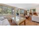 Inviting living room with wood tile flooring, large windows, and direct access to an outdoor area at 20 Lido Rd, Winter Springs, FL 32708