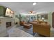 Comfortable living room with fireplace, lots of light, and plush seating for relaxing with Gathering and friends at 20 Lido Rd, Winter Springs, FL 32708