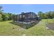 Backyard view of a screened-in pool with outdoor lounge furniture, offering a private oasis at 20 Lido Rd, Winter Springs, FL 32708