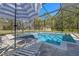 A stunning screened-in pool area with lounge chairs and a sun umbrella, perfect for relaxation and outdoor enjoyment at 20 Lido Rd, Winter Springs, FL 32708