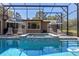 This screened pool area has plenty of seating with an attached jacuzzi on the back of the house at 20 Lido Rd, Winter Springs, FL 32708