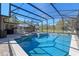 The beautiful tiled pool and jacuzzi are screened in with a view of the yard at 20 Lido Rd, Winter Springs, FL 32708