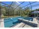Inviting pool with a spa, surrounded by a screened enclosure offering privacy and views of the natural surroundings at 20 Lido Rd, Winter Springs, FL 32708