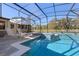 A tiled, screened-in pool with a jacuzzi and plenty of seating with yard view at 20 Lido Rd, Winter Springs, FL 32708