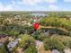 Aerial view of property, nestled among mature trees and boasting a stunning lake view at 226 Ringwood Dr, Winter Springs, FL 32708