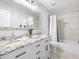 Bright bathroom with a double sink vanity, granite counters, and a shower/tub combo at 226 Ringwood Dr, Winter Springs, FL 32708