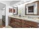 Updated bathroom featuring dual sinks with granite countertops and custom wood cabinets at 226 Ringwood Dr, Winter Springs, FL 32708