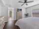 Bright bedroom includes a dresser with a TV, access to a screened porch, and hardwood floors at 226 Ringwood Dr, Winter Springs, FL 32708