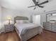 Cozy bedroom showcasing a queen-sized bed, ceiling fan, and ensuite bathroom access at 226 Ringwood Dr, Winter Springs, FL 32708