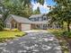 Charming two-story home with brick accents, lush landscaping, and a spacious driveway at 226 Ringwood Dr, Winter Springs, FL 32708
