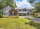 Charming two-story home with brick accents, lush landscaping, and a spacious front lawn at 226 Ringwood Dr, Winter Springs, FL 32708