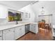 Spacious kitchen with white cabinets, quartz countertops, and a well-lit breakfast nook at 226 Ringwood Dr, Winter Springs, FL 32708