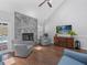 Cozy living room with a marble fireplace, hardwood floors, and views of the outdoor pool at 226 Ringwood Dr, Winter Springs, FL 32708