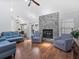Open living room showcasing a marble fireplace, modern seating, and hardwood flooring at 226 Ringwood Dr, Winter Springs, FL 32708