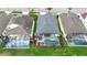 Birds-eye view of a home, highlighting the pool and surrounding green space in a residential neighborhood at 2263 Wyndham Palms Way, Kissimmee, FL 34747