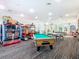 Spacious arcade room with a pool table, ping pong, and variety of arcade games for endless fun at 2263 Wyndham Palms Way, Kissimmee, FL 34747